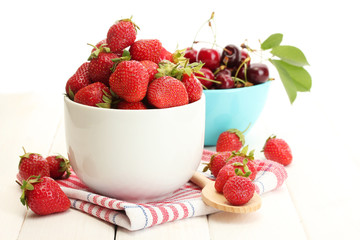 Ripe strawberries and cherry berries in bowls
