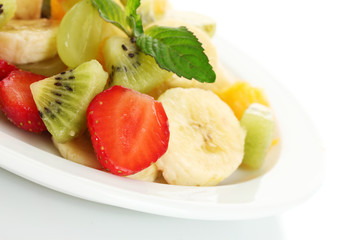 Fresh fruits salad on plate isolated on white