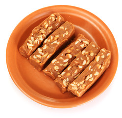 Cut east sweets - sherbet with nuts in the plate isolated