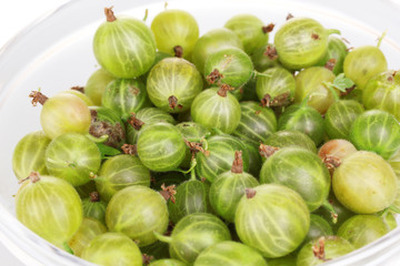 Green gooseberry in glass bowl close-up
