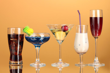 a variety of alcoholic drinks on yellow background