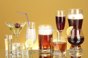 a variety of alcoholic drinks on yellow background