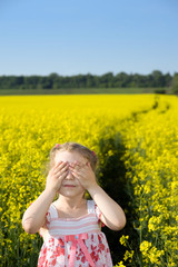Little girl on yellow field