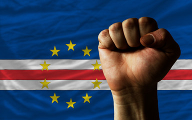 Hard fist in front of cape verde flag symbolizing power