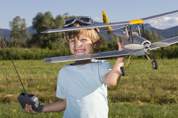 Smiling happy young boy and his RC plane