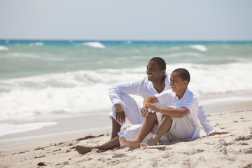 Fototapeta premium Happy African American Father and Son On Beach
