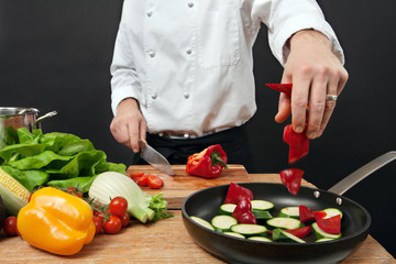 Chef adding ingredients