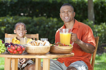 African American Father & Son Eating Healthy Food Outside