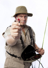 Fototapeta premium Fly fisherman holding out his favourite bait.