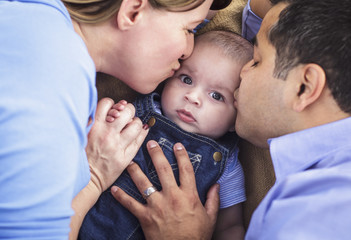 Mixed Race Parent Kissing Their Son