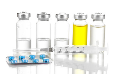 Syringe with medical ampoule and tablets isolated on white
