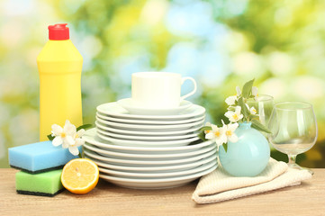 empty clean plates, glasses and cups with dishwashing liquid,