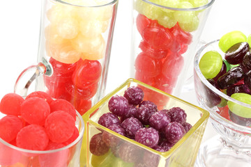 Color candies in glasses isolated on white