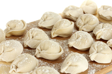 Fototapeta na wymiar Raw Dumplings on cutting board on white background close-up