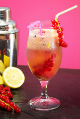 fruit cocktail with mixer over pink background
