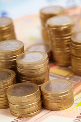 Euro coins on banknote money background