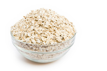 Uncooked oatmeal in a glass bowl with clipping path