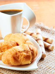 Breakfast with coffee and croissants