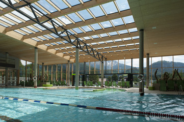 indoor architecture of public swim bath with laps and glass roof