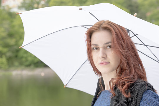 Young woman with a white umbrella