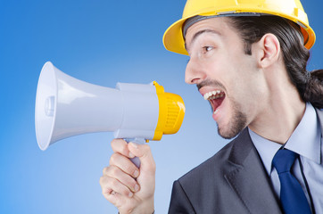 Fototapeta premium Construction worker shouting via loudspeaker