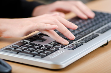 Hands typing on the keyboard