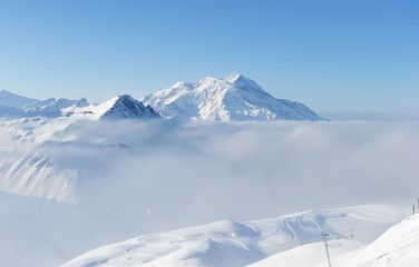 Mountains in clouds with snow in winter