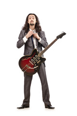 Obraz na płótnie Canvas Guitar player in business suit on white
