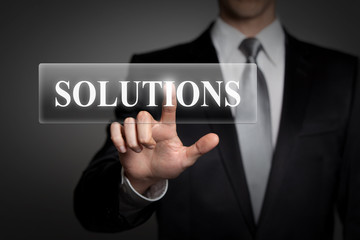 businessman pressing virtual button - solutions