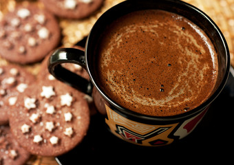 Closeup of chocolate cookies and a cup of coffee
