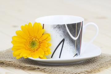 cup of coffee with orange gerbera