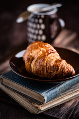 Croissant and two old books