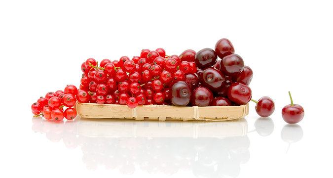 ripe red currant and ripe cherry on a white background