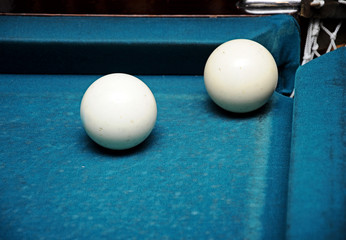 closeup white billiard balls near the pockets