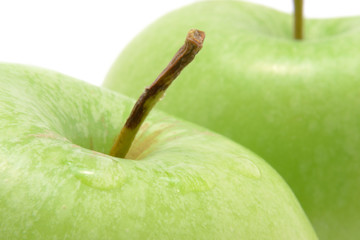 Two green apples isolated over white