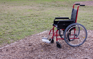 Fototapeta na wymiar Empty wheelchair in parkland