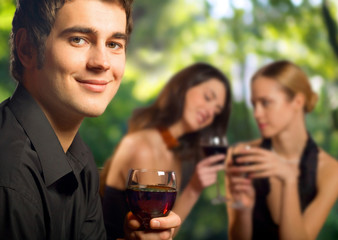 Young man with red wine