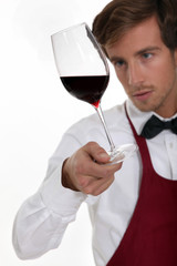 Sommelier with a glass of red wine