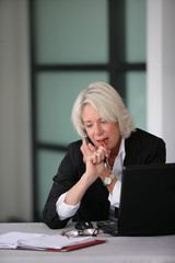 senior businesswoman working at her desk
