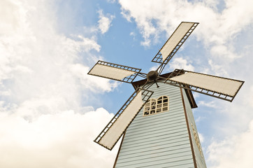 windmill over cloudy sky