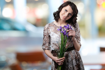 portrait of a girl with flowers in the urban background