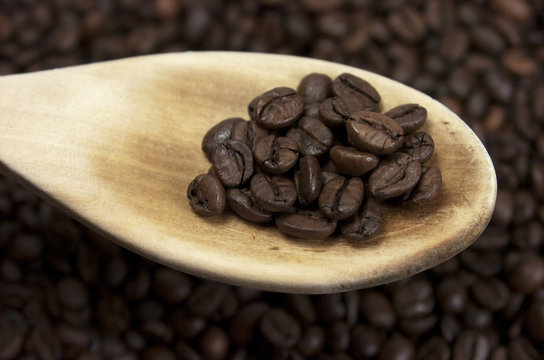Cuchara de madera con granos de caf&eacute;