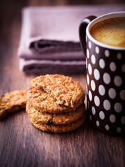 Mug of coffee and rustic cookies with nuts