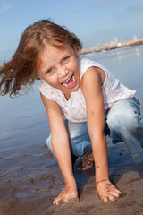 cheerful little girl at the beach