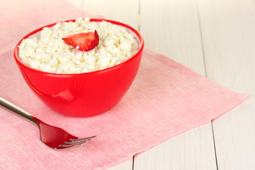 cottage cheese with strawberry in red bowl and fork