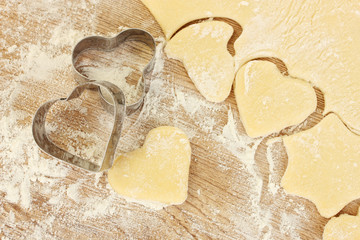 tins of cookies on the rolled out dough close-up