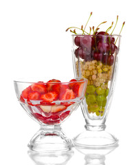 Mixed fruits and berries in glasses isolated on white