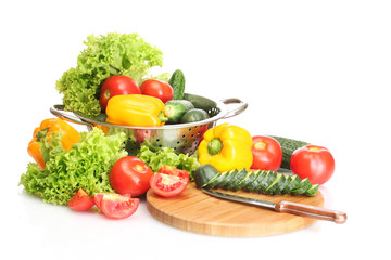 fresh vegetables and knife on cutting board isolated on white