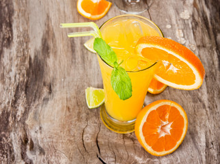 Orange cocktail on wood, top view