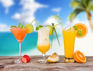 Summer cocktails with blur beach on background